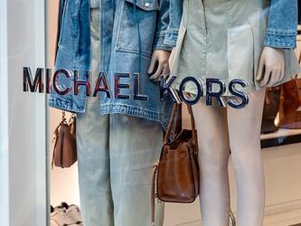 michael kors store window displaying fashion mannequins